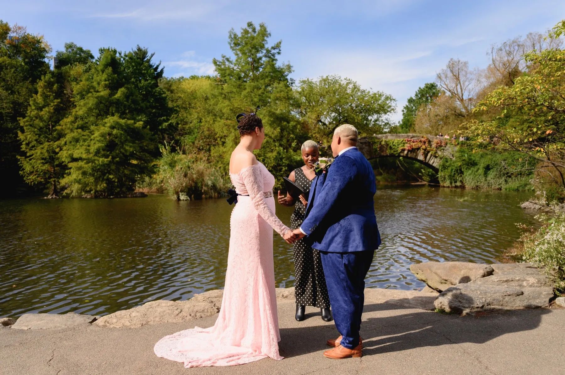 Veronica + Julie celebrating after the ceremony at Gapstow Bridge, Central Park Wedding