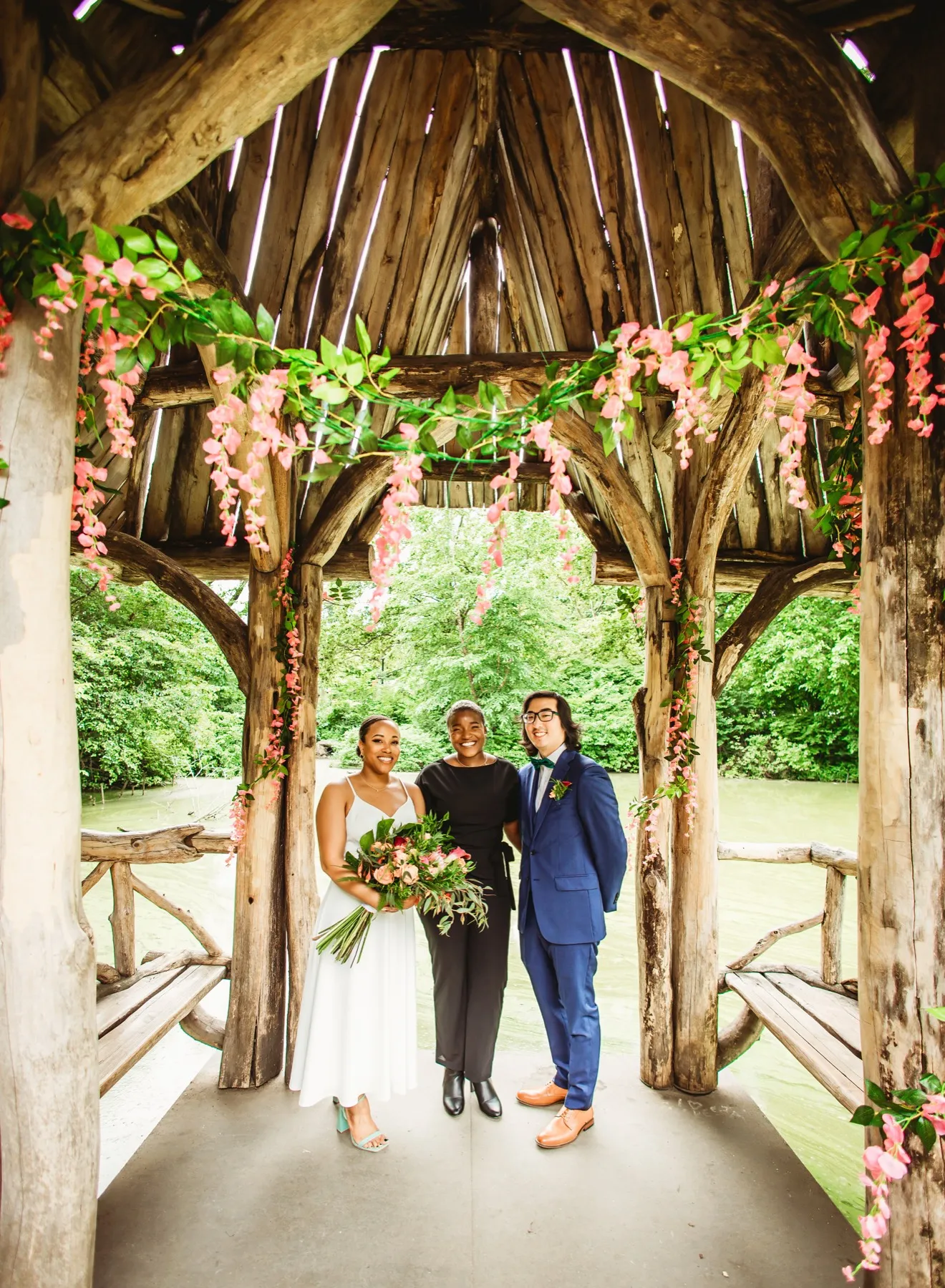 A couple with Robyn Walker under the Cop Cot arch in Central Park