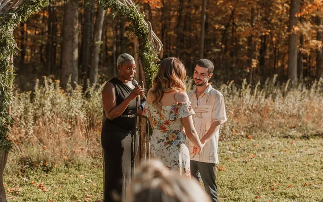 A couple joining hands during their wedding ceremony