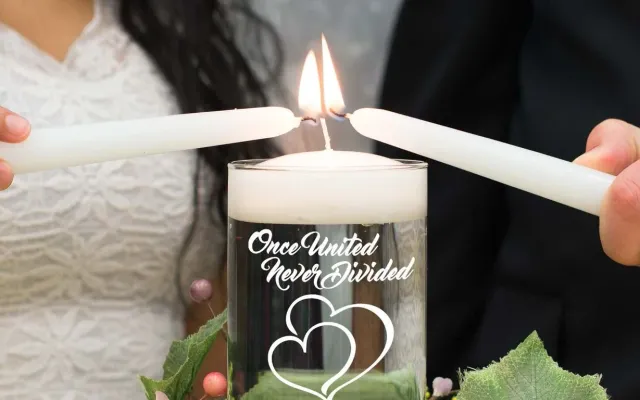 A couple lighting a unity candle during their wedding