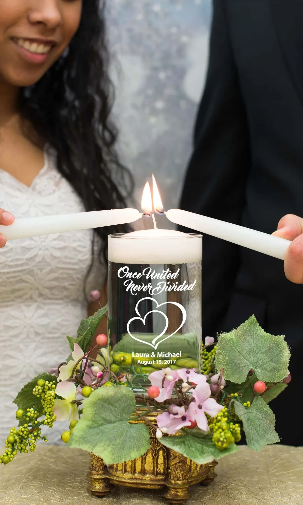 A couple lighting a unity candle during their wedding