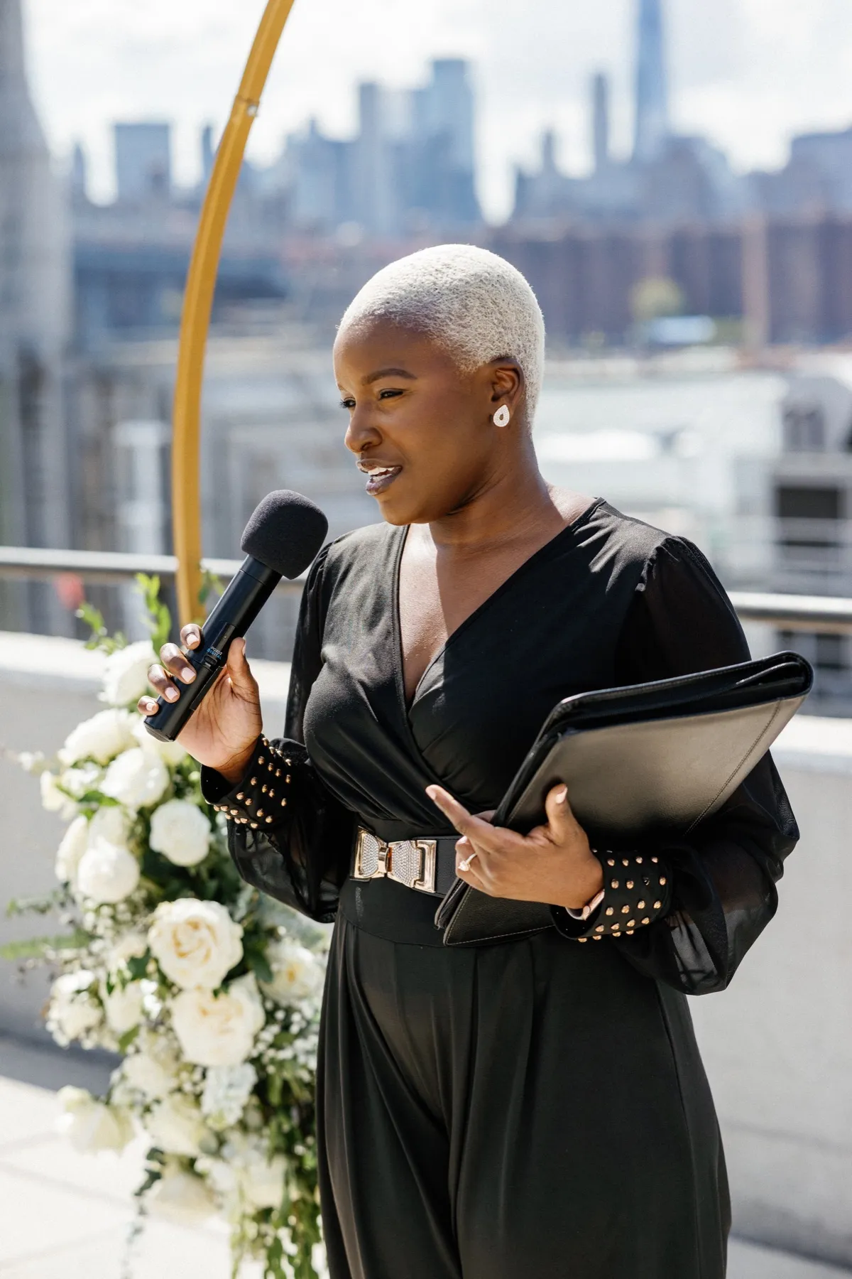 Robyn Walker mid-ceremony, holding the room