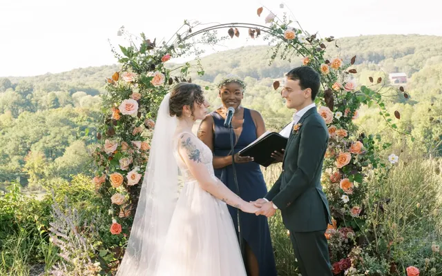 A newly married couple kissing after their ceremony